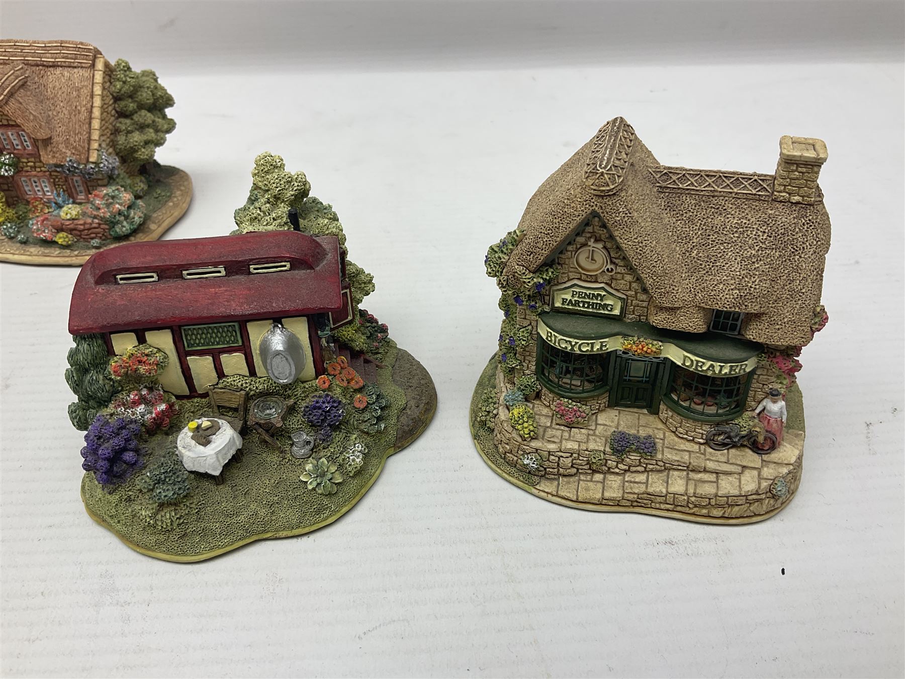 Eighteen Lilliput Lanes, including The Penny Farthing, The Pigsty, Borrowdale School, Fairy Cake Tearoom, An Apple a Day,Ladybird Cottage etc, all with original boxes 