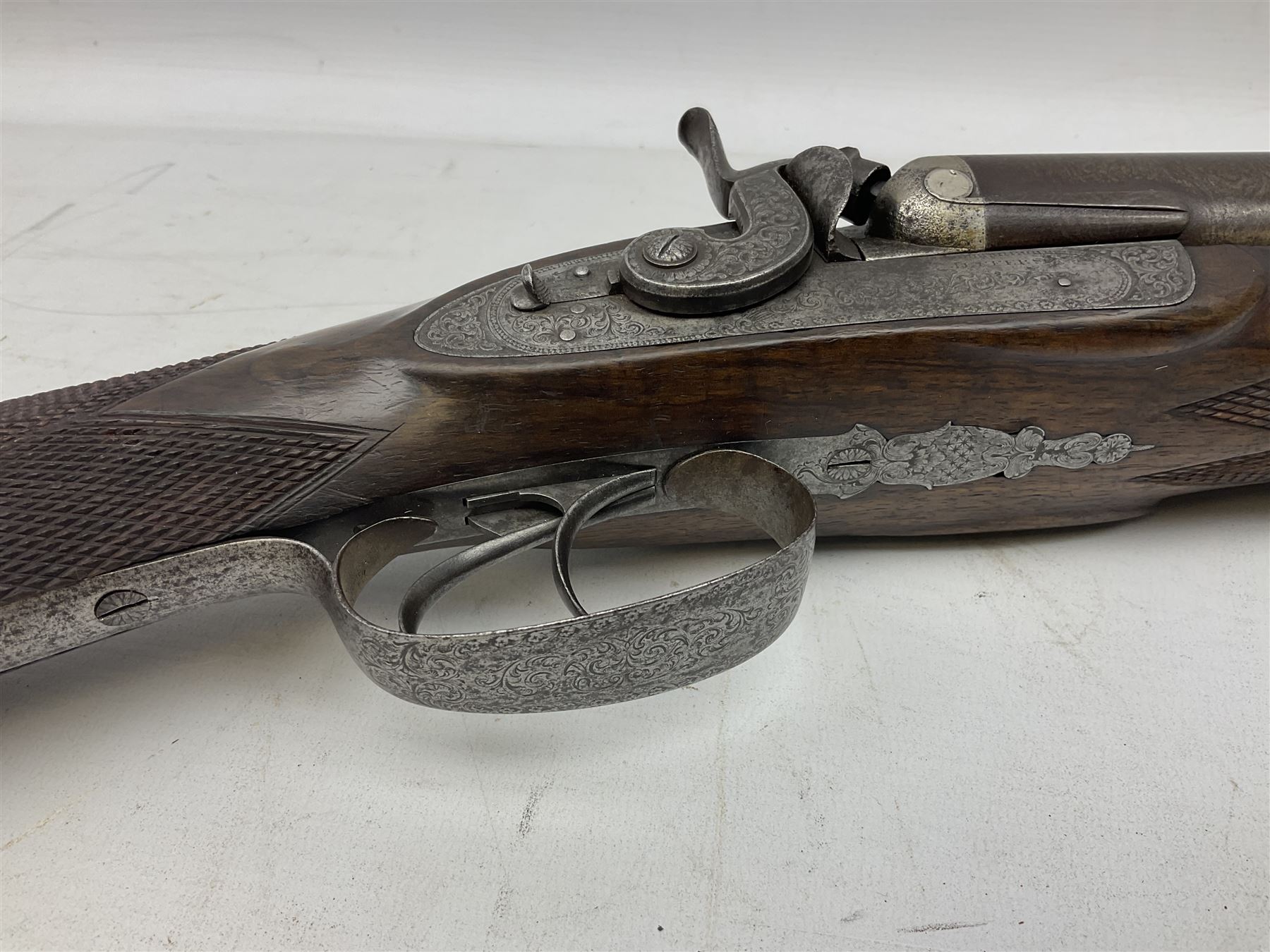 19th century John Jefferson of Scarborough 6-bore (modern 4-bore) double barrel side-by-side percussion gun, with 81cm stub twist damascus barrels (no provision for ramrod), well figured walnut stock with fine chequered grip and fore-end with horn tip and steel butt plate with long tang, well engraved lock and hammers with half-cock safeties on both sides, barrel sling swivel but rear sling swivel removed and replaced with silver escutcheon, London proofmarks, NVN, L128cm
