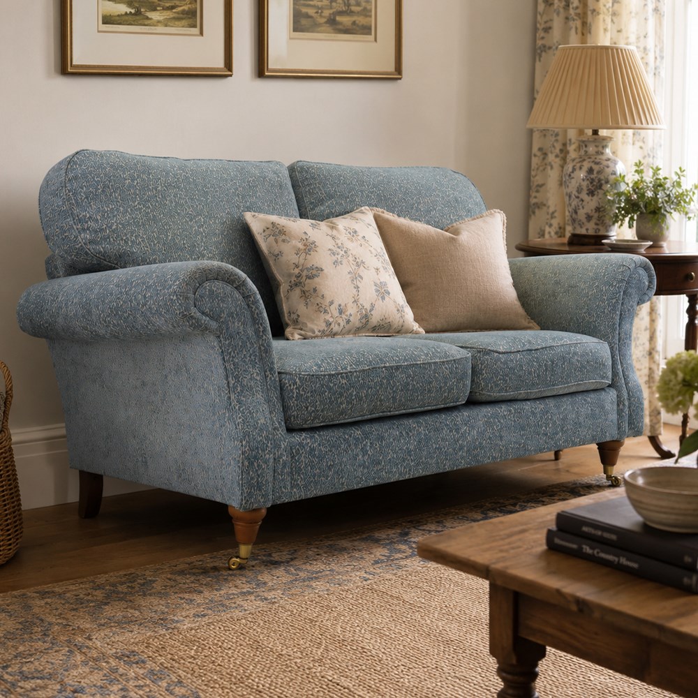 Marks & Spencer - 'Salisbury' two seater sofa, upholstered in blue fabric, scrolled arms and loose cushions