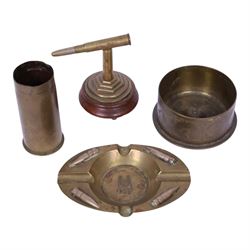Collection of trench art, including a vase with scalloped rim, applied with a helmet plate to the 45th regiment, mounted on a canted rectangular walnut plinth, together with ashtray with matchbox holder to the center, pair of Boer war vases etc 