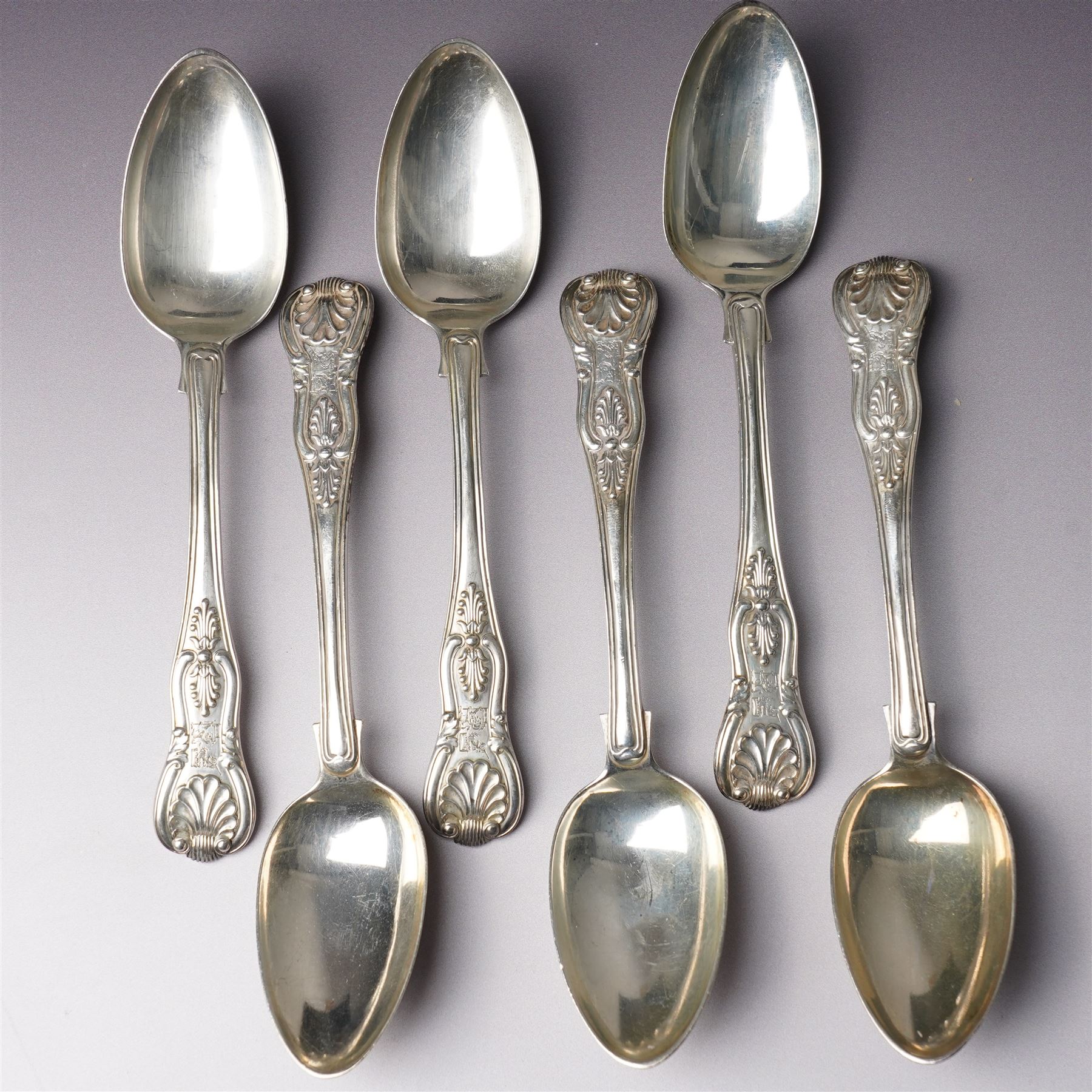 Set of six George IV silver Kings pattern dessert spoons London 1825 Maker Charles Eley  and four 19th century Kings pattern silver dessert forks, various dates
