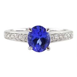 18ct white gold oval tanzanite ring, with channel set round brilliant cut diamond shoulders, stamped 750, tanzanite approx 0.85 carat