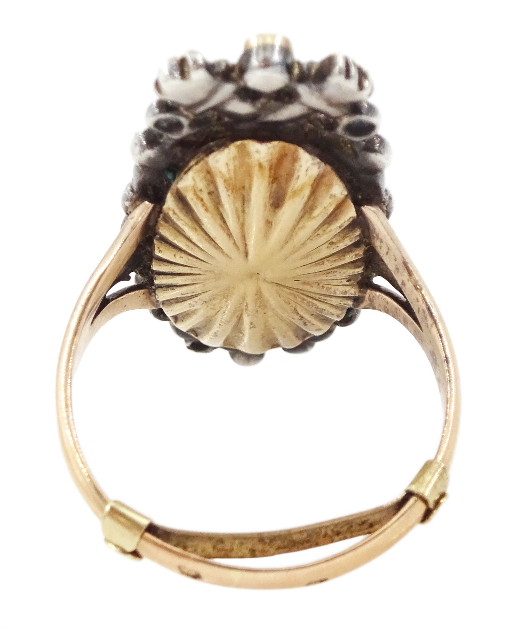 18th / 19th century silver and gold diamond and sapphire portrait ring, set with an oval miniature of a woman wearing a bonnet on ivory, under a glazed panel, surmounted with a 'trophy of love' symbol, modelled as a flaming torch and bow and quiver, set with a single round cut sapphire and rose cut diamond surround, to trifurcated shoulders, on French 18ct gold shank, Eagle hallmark. This lot has been registered for sale under Section 10 of the APHA Ivory Act