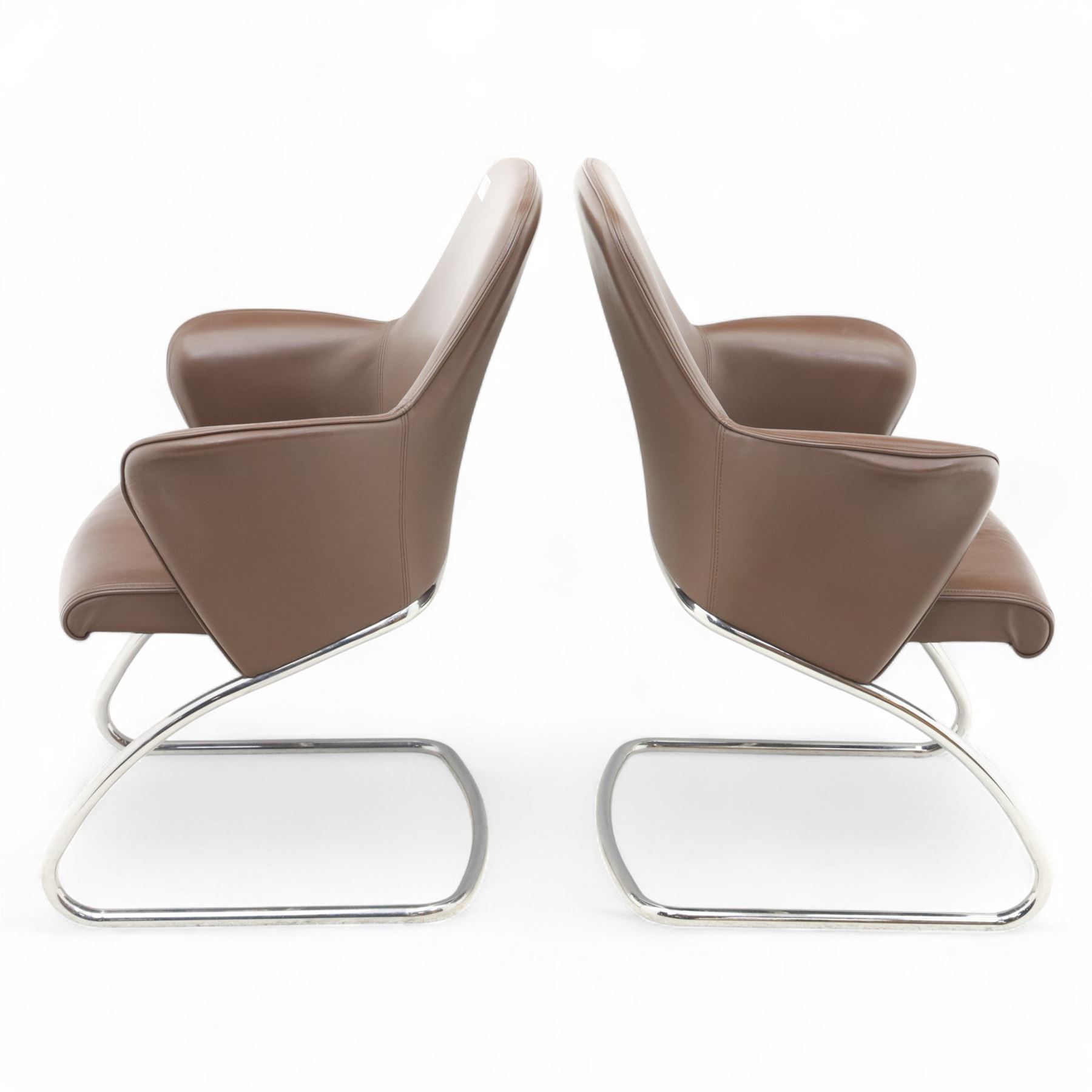 Two Senator executive cantilever chairs, upholstered in Padova hide, moulded back and integrated armrests, raised on a tubular chromed cantilever base