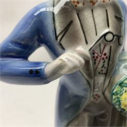 Goldscheider figure, modeled as a gentleman with flowers, upon a circular base, with printed mark beneath, H25cm