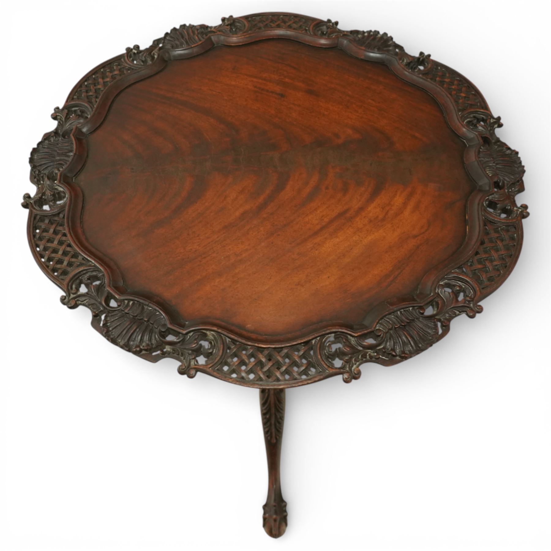 Late 19th century Rococo Revival mahogany occasional table, with shaped circular top with ornate lattice-pierced edge, decorated with pierced scallop motifs and acanthi, raised on a birdcage movement over turned pedestal, terminating to foliate-moulded tripod base with ball and claw feet