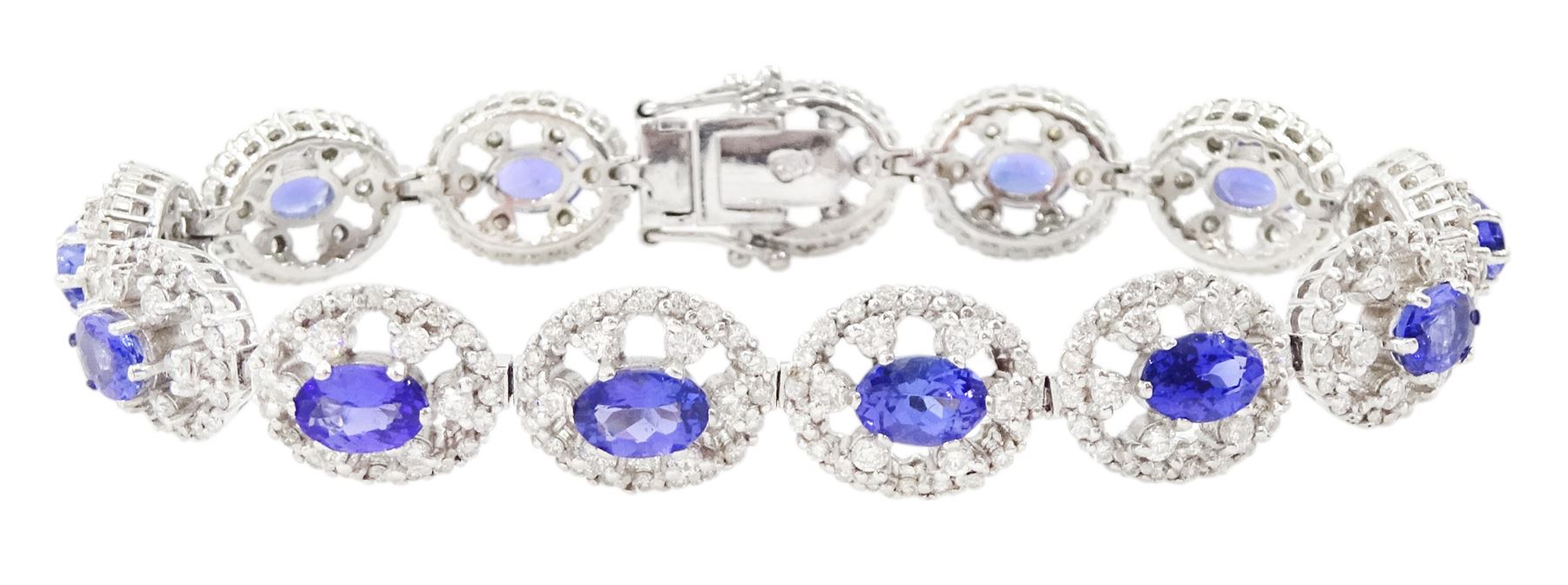 18ct white gold tanzanite and diamond bracelet, twelve oval link clusters set with oval cut tanzanite's and round brilliant cut diamonds, stamped 750, total tanzanite weight approx 7.15 carat, total diamond weight approx 4.00 carat