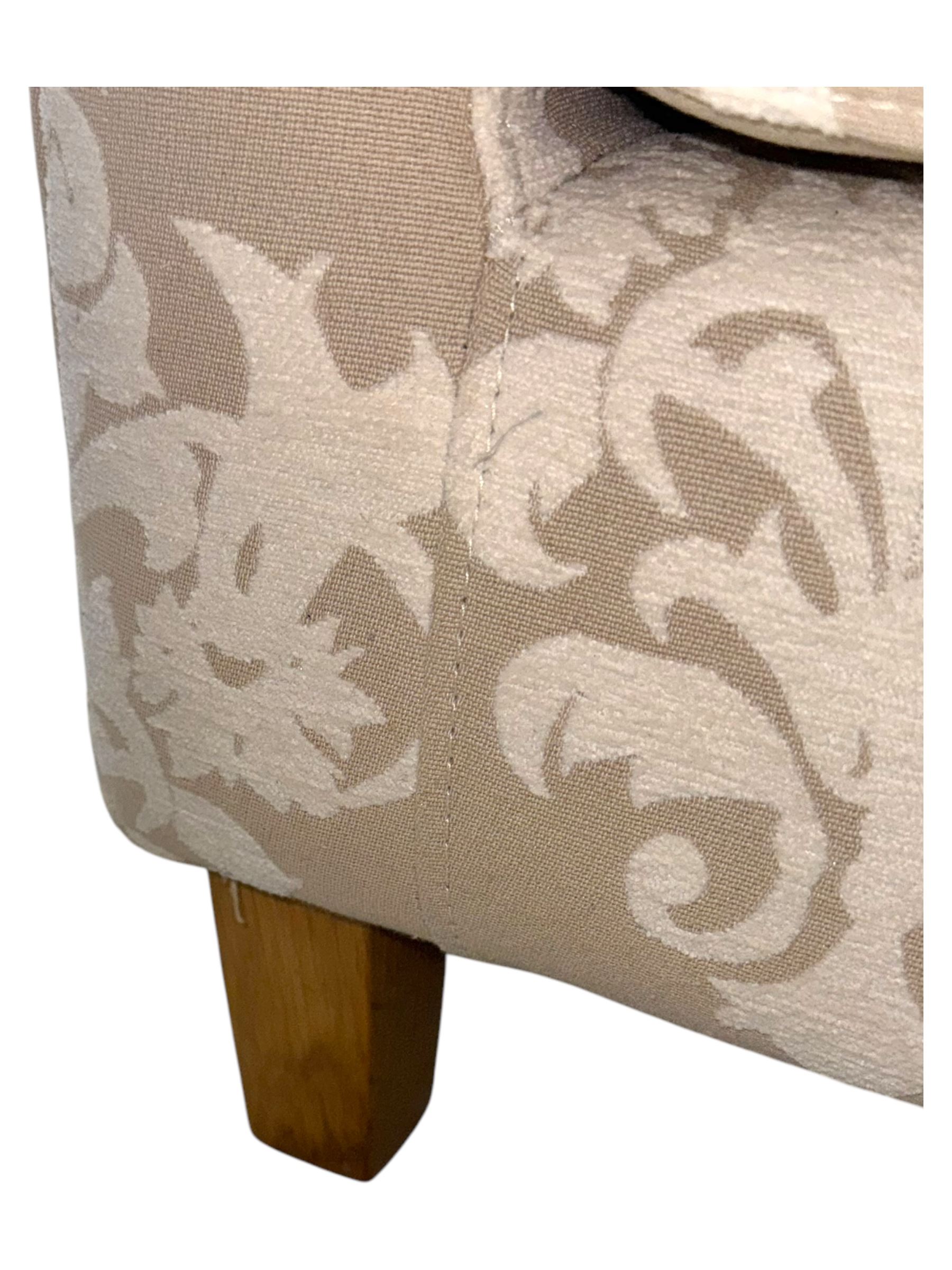 Chatsworth hardwood-framed armchair upholstered in cream  damask, with rolled arms and cushioned seat, raised on square tapered feet