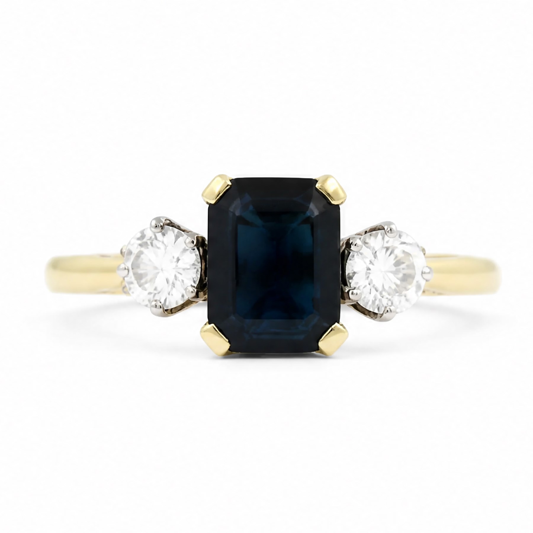 18ct gold sapphire and diamond three stone ring, single octagonal cut sapphire of approx 0.90 carat, with a round brilliant cut diamond set either side, London 1996, total diamond weight approx 0.30 carat