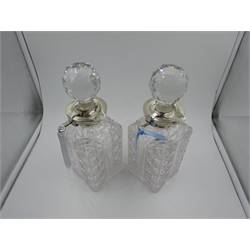  Pair of silver mounted cut glass decanters, with hinged lock and key and pouring lips by George Betjemann & Sons, London 1904/5, H26.5cm  