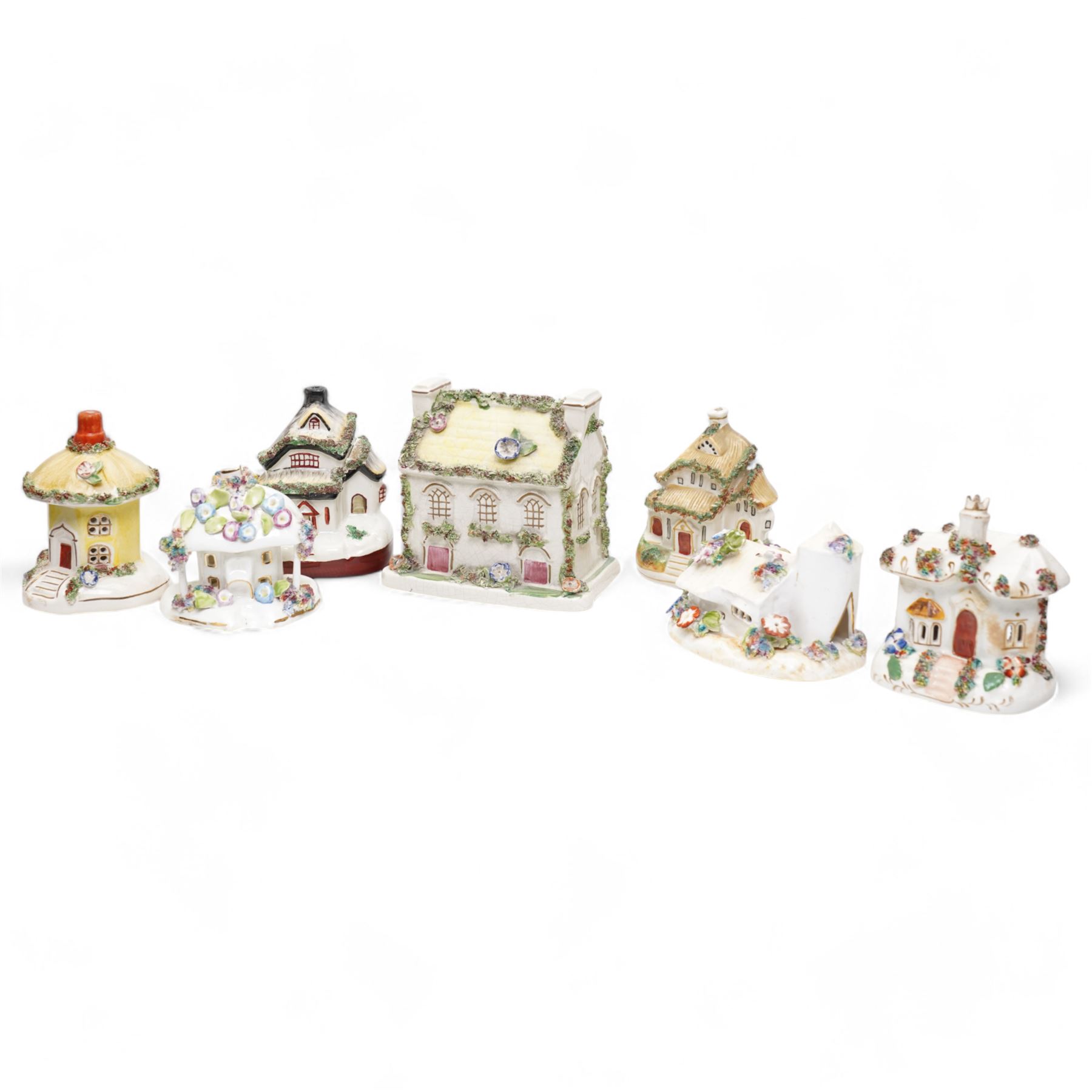 19th century pottery money box in the form of a two storey house with applied floral decoration W14cm  and six pottery cottage pastille burners