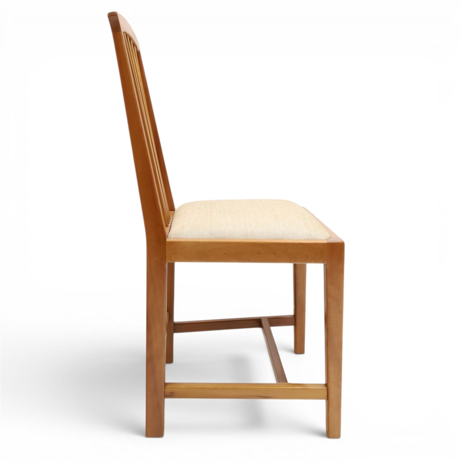 Knightman - set of nine cherrywood dining chairs, with fan splat backs and upholstered seats, raised on square legs joined by stretchers, comprising chairs of slight differing widths and one chair with turned front legs and orange upholstery and no Knight carving, the rest with recessed carved knight trademark, by Horace Knight of Old Mill Furniture, Balk near Thirsk 