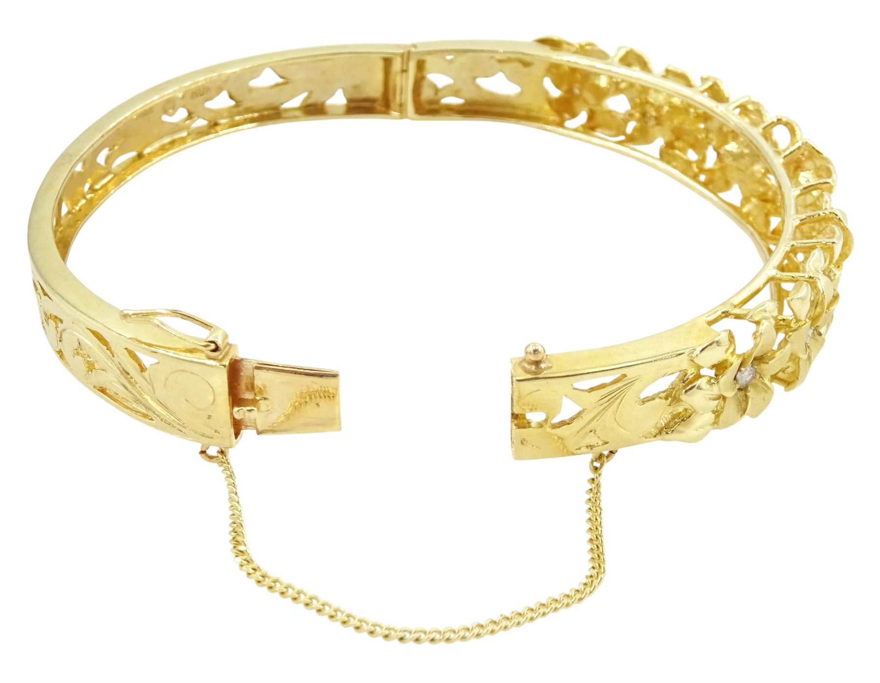 14ct gold diamond flower head hinged bangle, seven graduating flowers, each set with a single round brilliant cut diamond, to a pierced and engraved foliate body, stamped