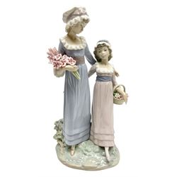 Lladro figure, Sisters, modelled as two sisters holding a basket of flowers and a floral bouquet, sculpted by Vincente Martinez, no 5013, year issued 1978, year retired 1991, H32cm  