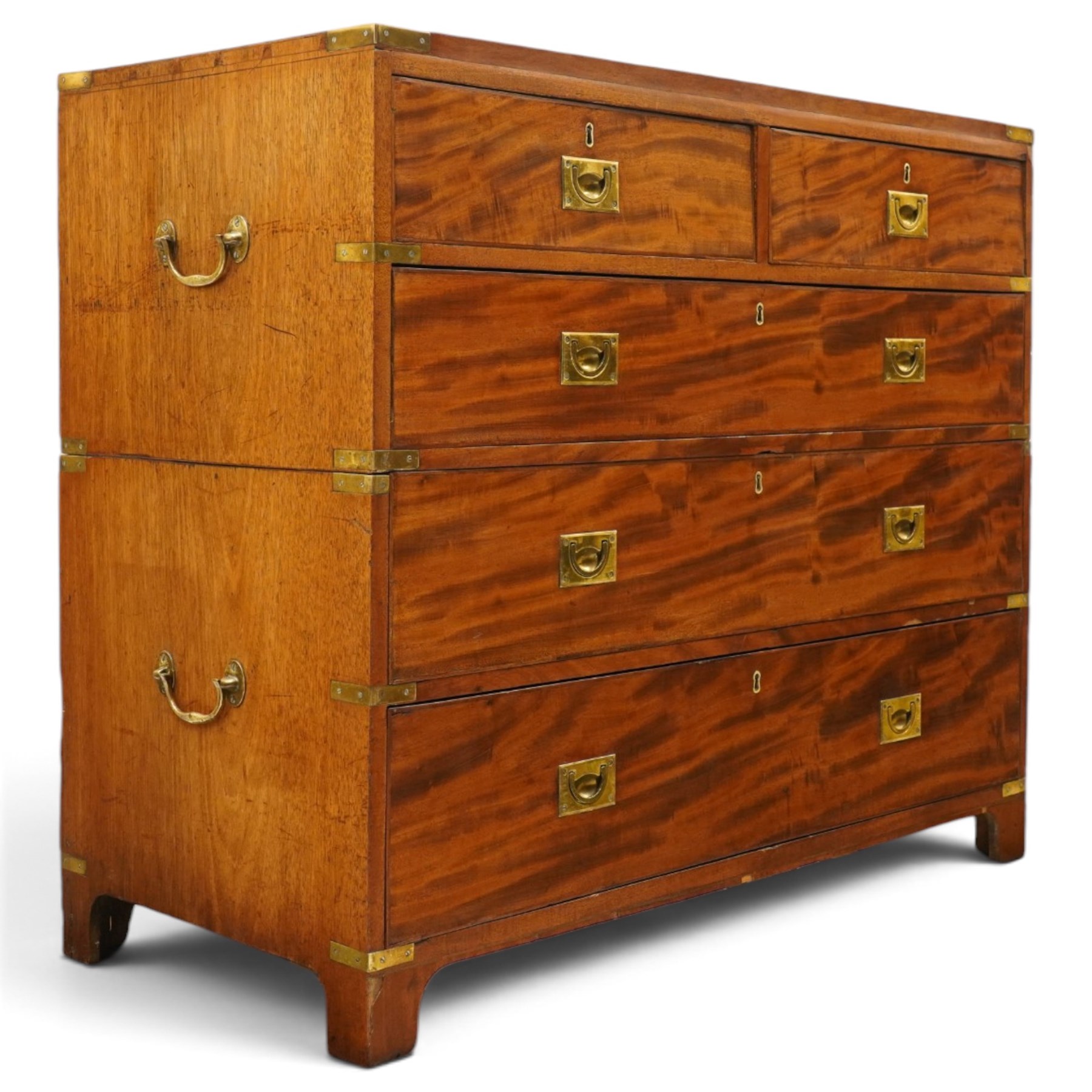 19th century figured mahogany military campaign chest of drawers in two sections, the rectangular top with brass-bound corners over two short and three long graduated drawers, each fitted with recessed brass campaign handles and escutcheons, the carcass with brass strapwork and carrying handles to the sides, raised on short bracket feet