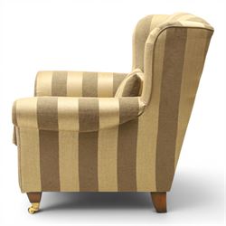 Alstons - 'Ixworth' armchair, upholstered in striped fabric, with loose seat cushions and scrolled arms, brass front castors