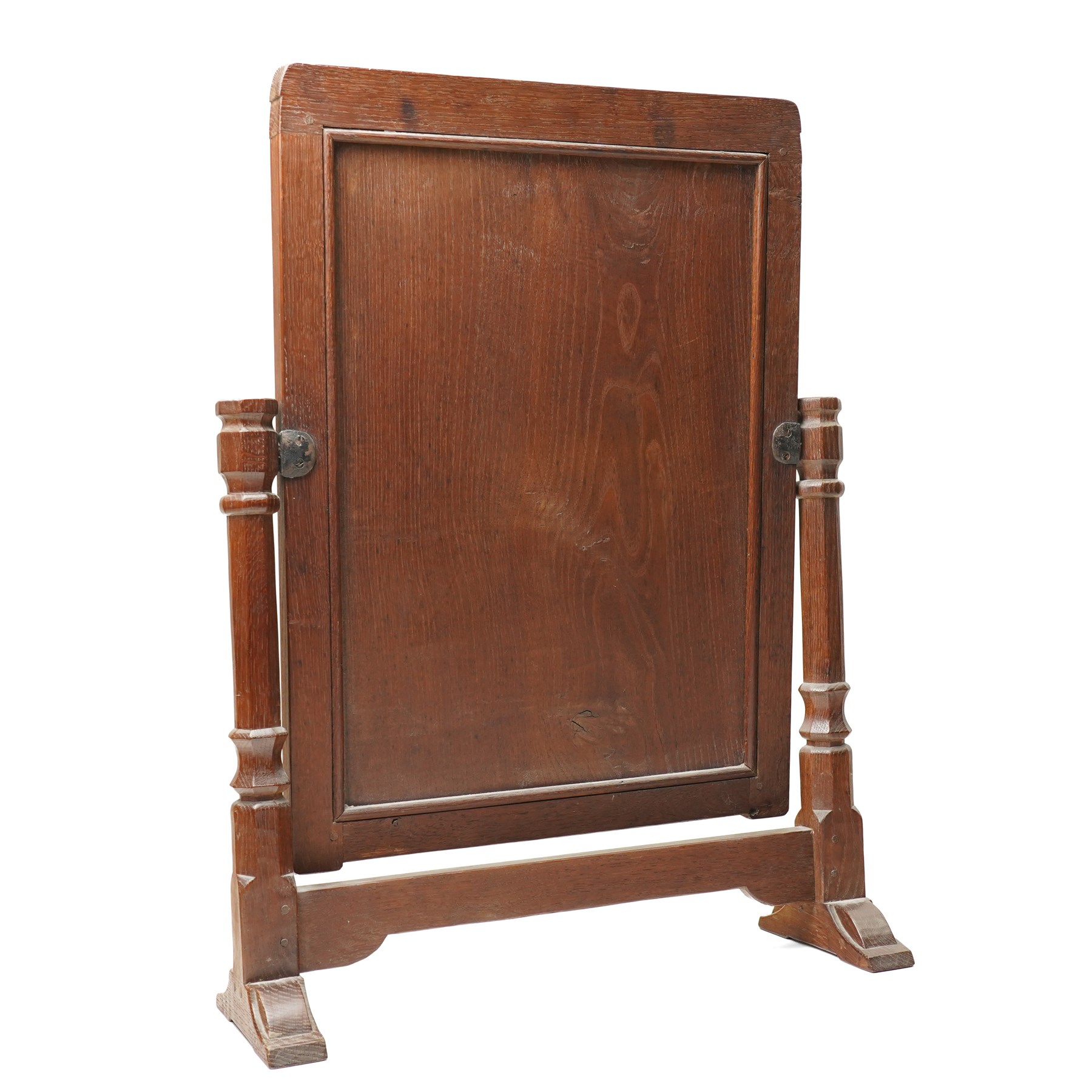Mouseman - 1930s/40s lightly adzed dark oak dressing table swing mirror, the arcade carved cresting rail over a rectangular plate, the mirror pivots between two lappet-carved turned octagonal supports with dished tops, raised on sledge feet, with carved mouse signature, by the workshop of Robert Thompson of Kilburn