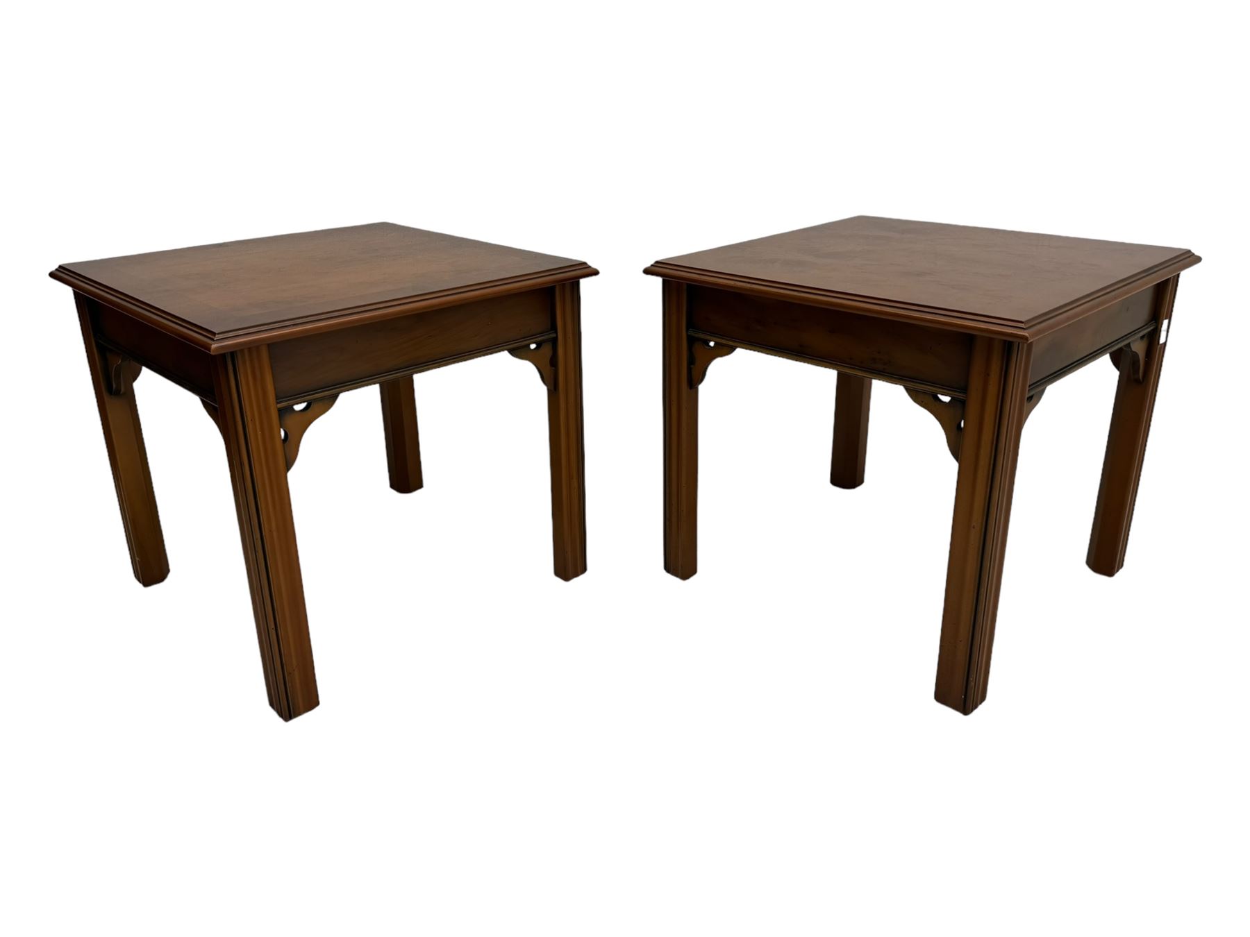 20th century pair of yew wood lamp tables, moulded square top with pierced corner brackets, on fluted straight supports 