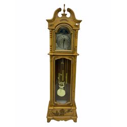 21st century replica longcase clock by “Wood & Son” in a incised light wood case with a swans neck pediment and finial, turned columns flanking a glazed broken arch hood door, trunk with a full length glazed door on a short stepped plinth, visible lyre pendulum with dummy chains and weights, 31 day going barrel movement striking the hours and half hours, brass and silver effect dial with roman numerals and decorative steel hands, faux (non- working) moon dial to the arch.