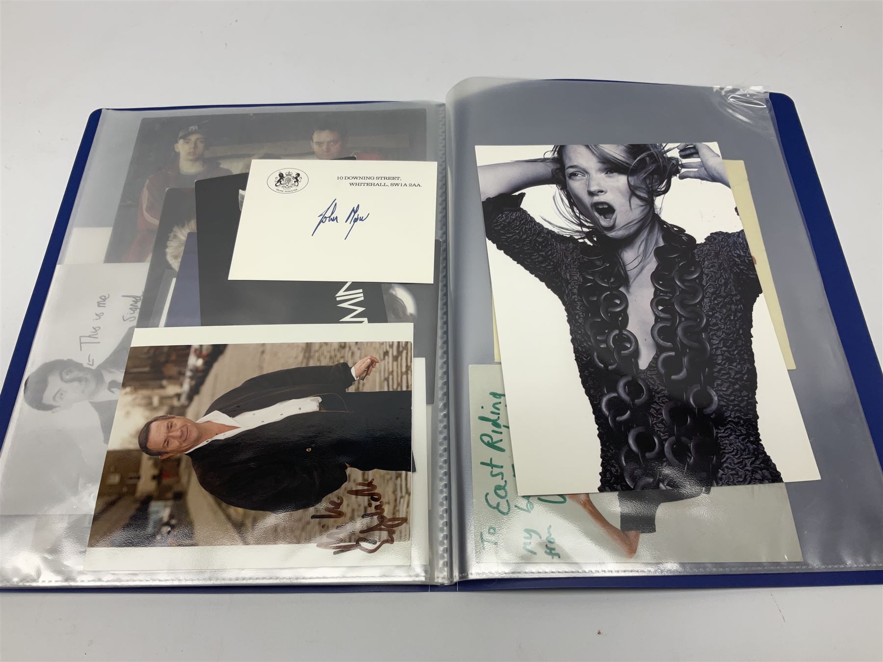 Two folders of over fifty photographs, cards, compliment slips etc of actors, actresses, celebrities, politicians, sports personalities etc, all bearing signatures, including David Frost, Lloyd Grosman, John Suchet, Julia Somerville and othe GMTV presenters, Carol Vorderman, Jackie Collins, Rolf Harris, Timothy Dalton, Pete Postlethwaite, Magnus magnusson, John Major, Kate Moss, Uri Geller, David Beckham, Peter Alliss, Sharon Davies, Kevin Keegan etc