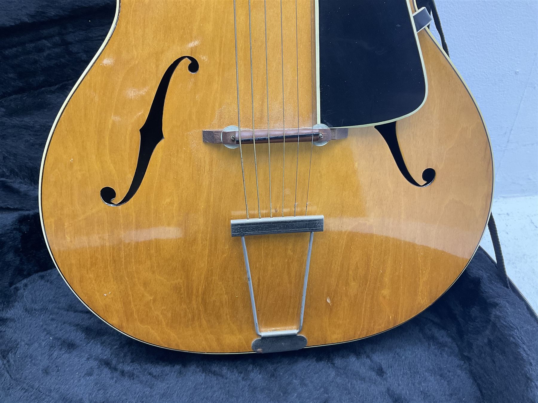 1950s acoustic guitar with f-holes and pickguard L105cm; black fur lined hard carrying case