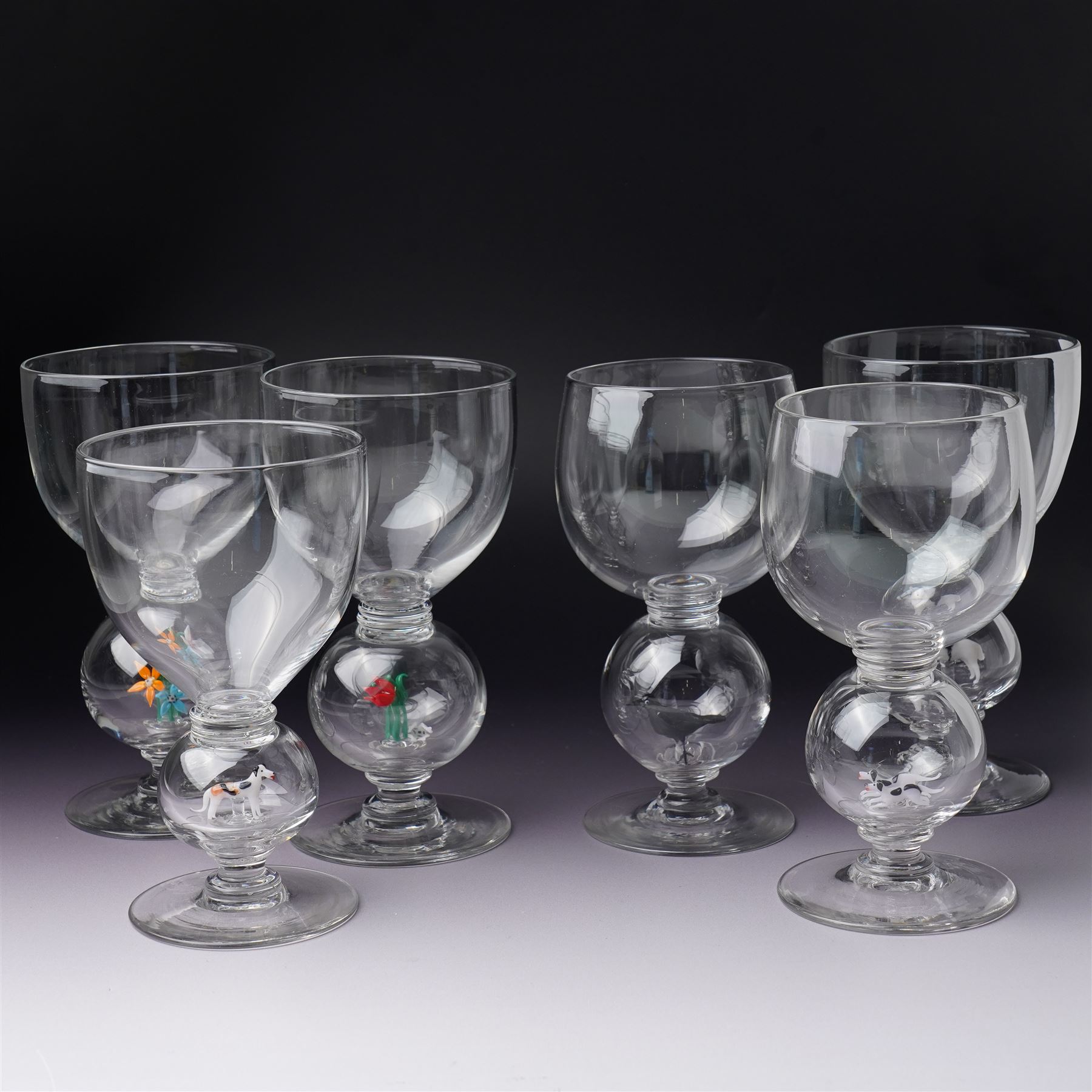 Set of six 1930s glass goblets by William Swingewood for Stevens & Williams, each goblet with lampwork glass stem, the large hollow blown knop containing dog, pair of hounds, horse, raven and two with flowers, H18cm (6)