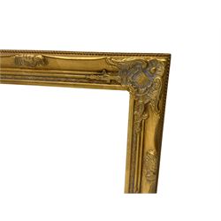 Pair bevelled edge wall mirrors in swept gilt frames decorated with ornate cartouches 