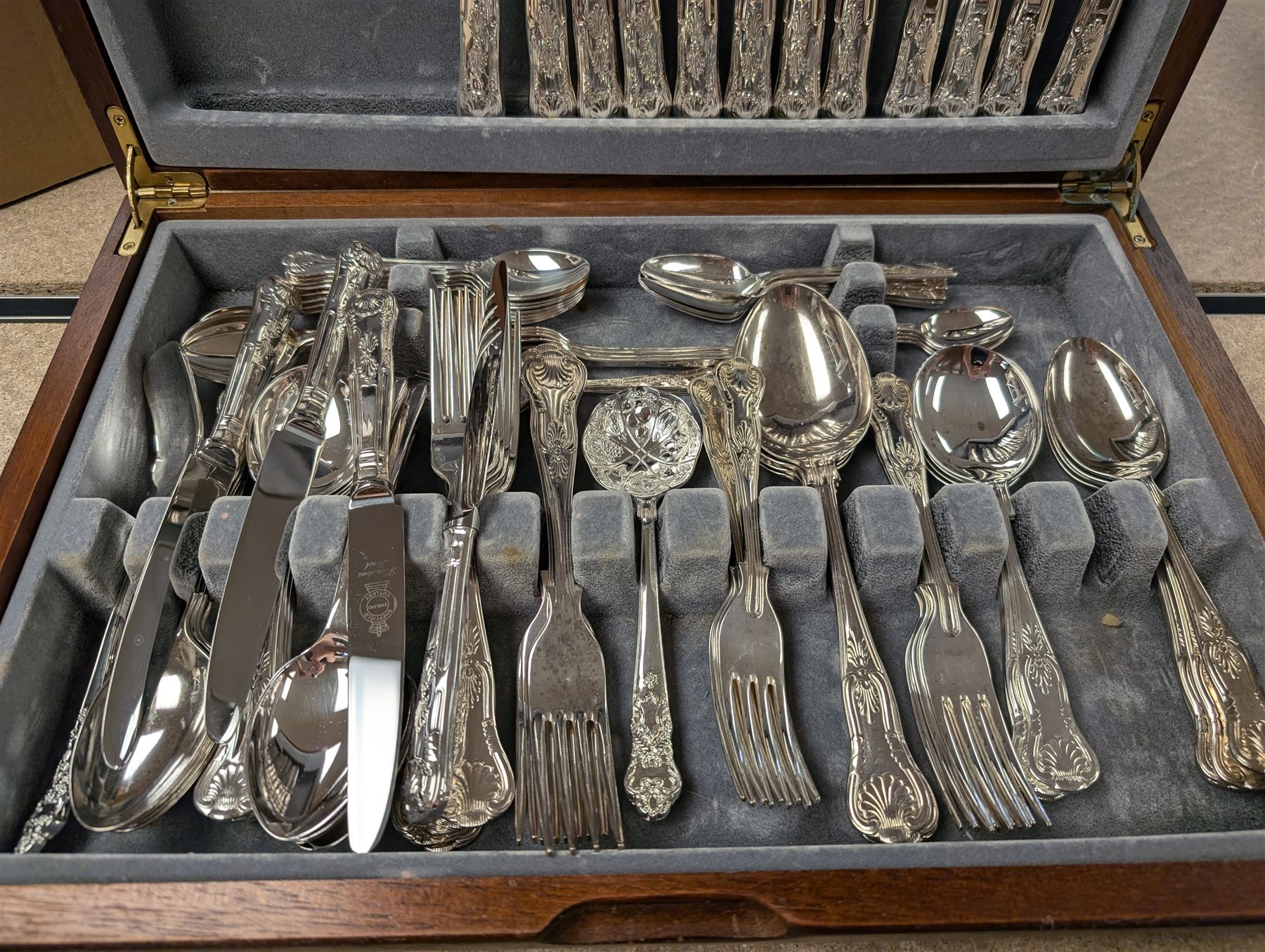 Three cased canteens of cutlery, including King's pattern set and two ivorine handled sets