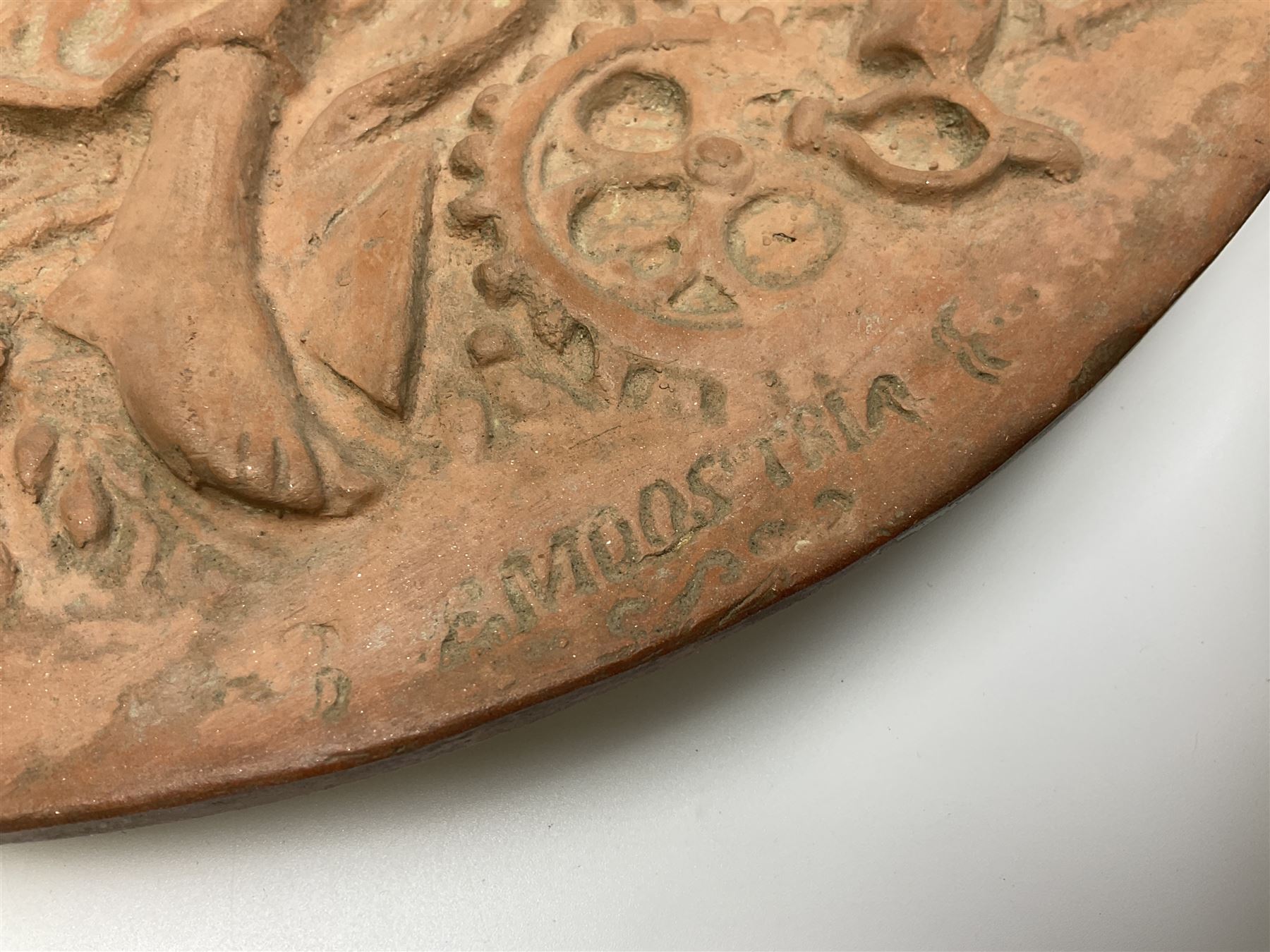 Pair of 19th century classical terracotta relief wall plaques depicting the goddess Hygeia and another goddess, seated holding an ewer, each of oval form, indistinctly signed, each stamped Ferreira verso, H42cm, W30cm