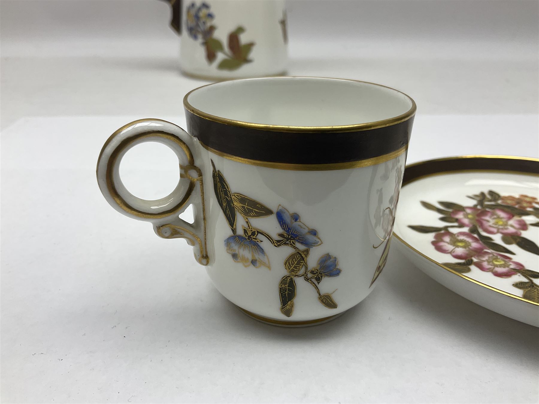 Royal Worcester coffee pot, coffee cup and saucer, all decorated with floral sprigs and butterflies, the coffee pot with a bamboo handle, H23cm