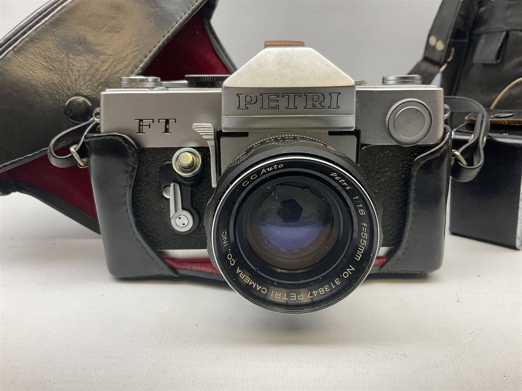 Petri FT 35mm SLR camera with a Petri 1:1.8 55mm lens, Petri Flex camera with a Petri 1:2 55mm Kuribayashi lens, together with cases and quantity of lenses etc