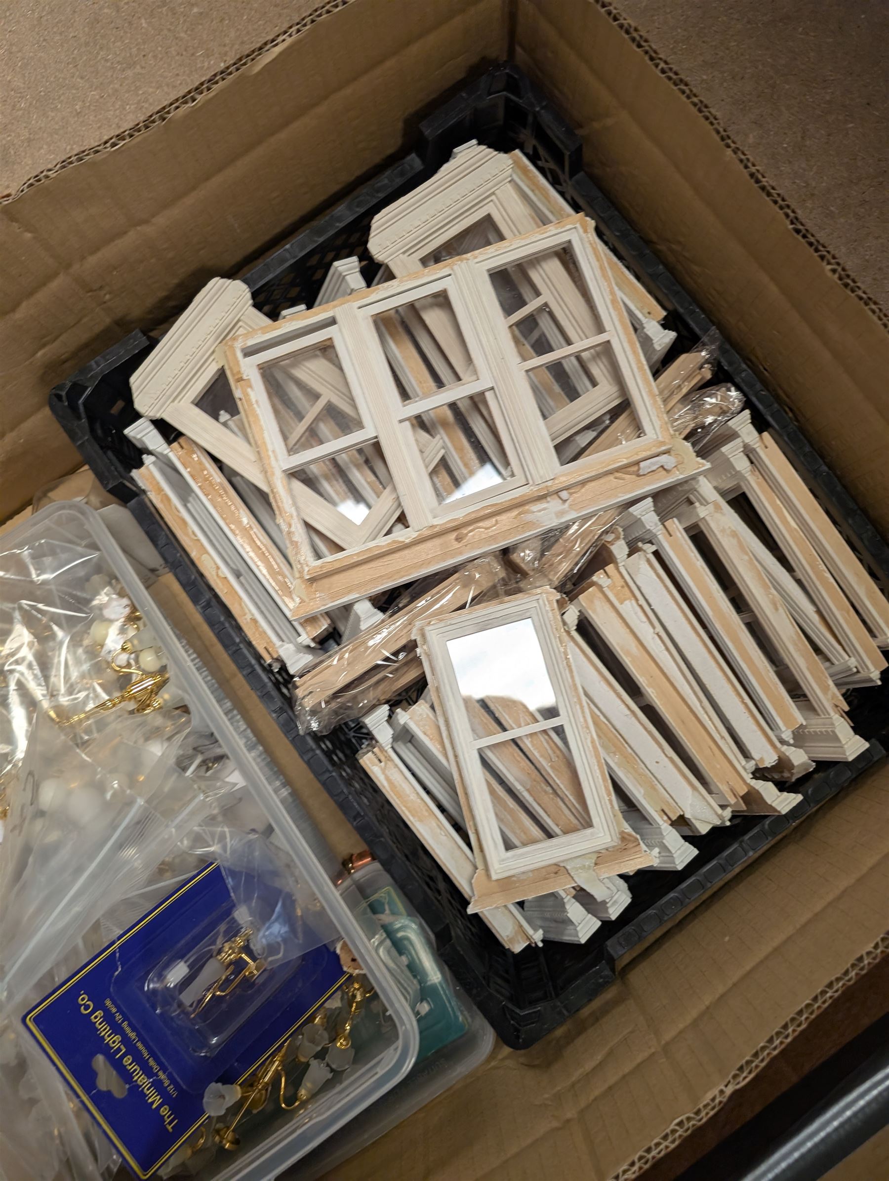 Dolls House building accessories, including three stair cases, a quantity of doors and windows, skirting board, coving, kitchen and fireplaces scenes and a collection of wired and non wired light fittings