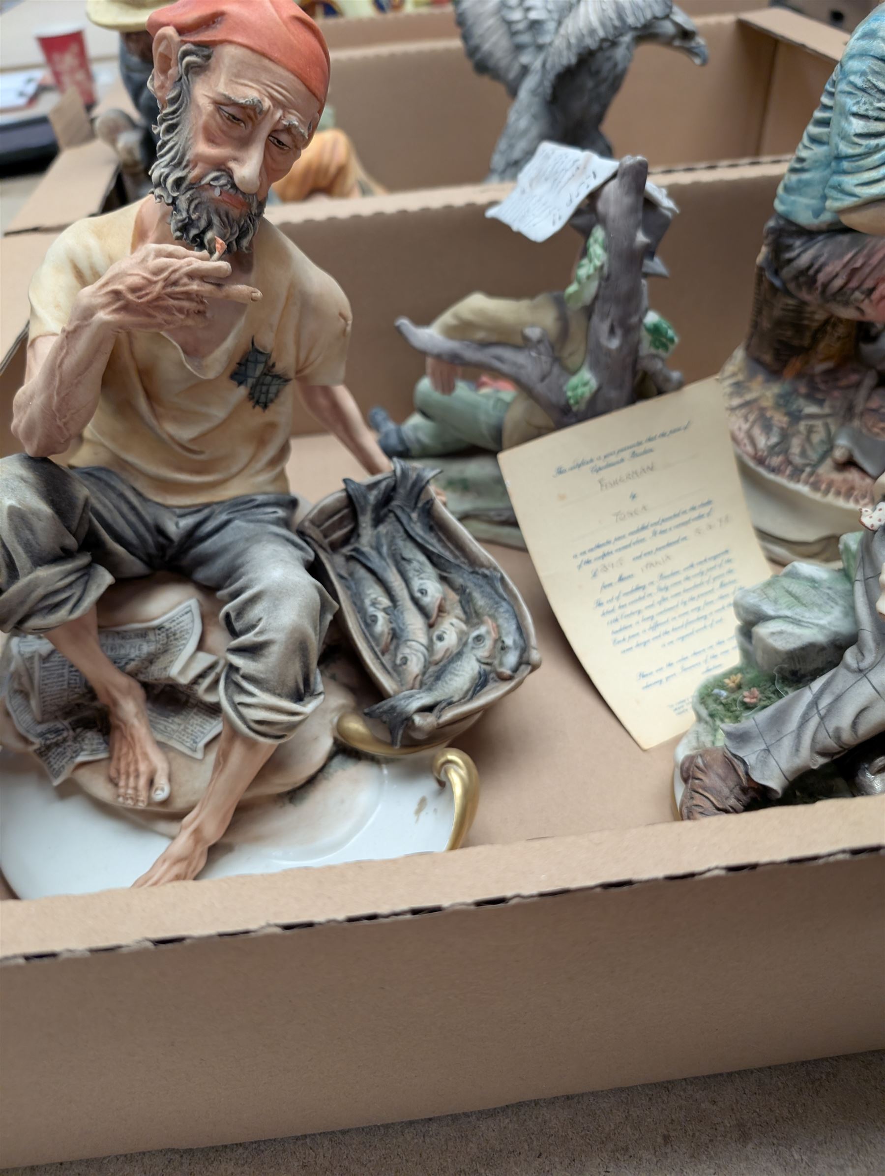 Six Capodimonte and similar figures, including Fisherman, Eagle and tramp examples, tallest 