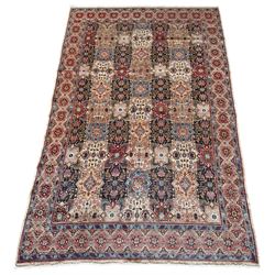 Persian Ardabil rug, the field with multiple geometric panels decorated with floral and stylised motifs, repeating guarded border