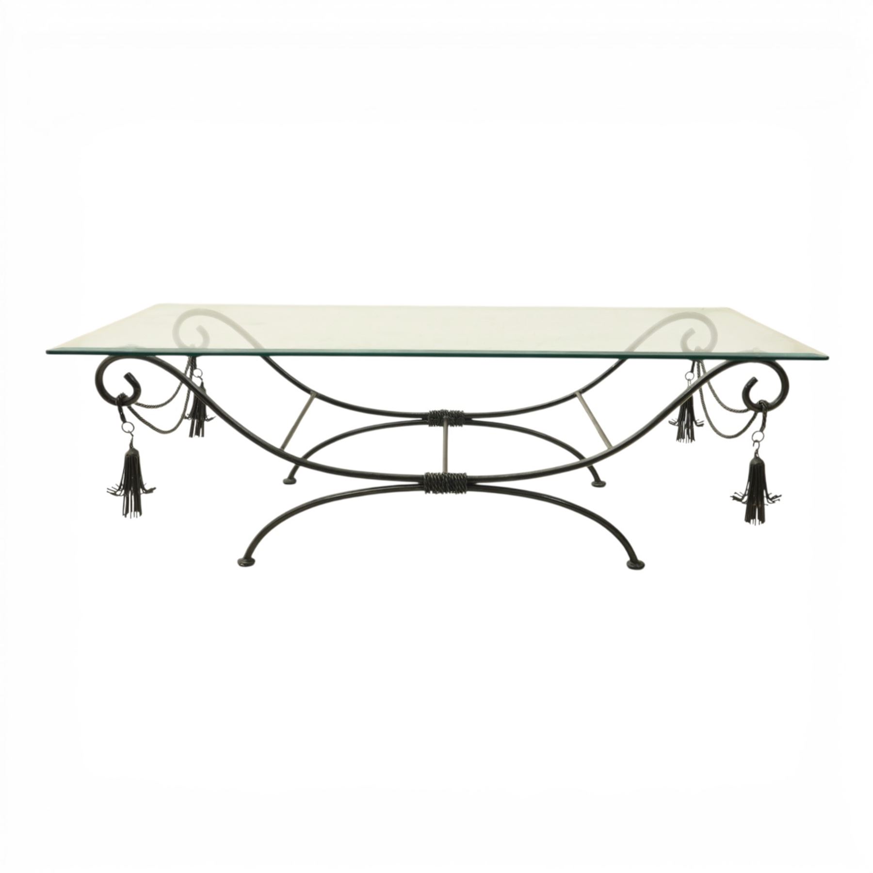 In the manner of Maison Jansen - Regency inspired glass and wrought metal coffee table with scrolling X-form base