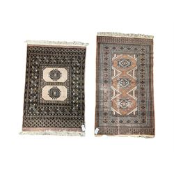 Person Bokhara lilac ground rug, two central Gul motifs surrounded by multi-band border (115cm x 79cm); together with another similar (132cm x 79cm)