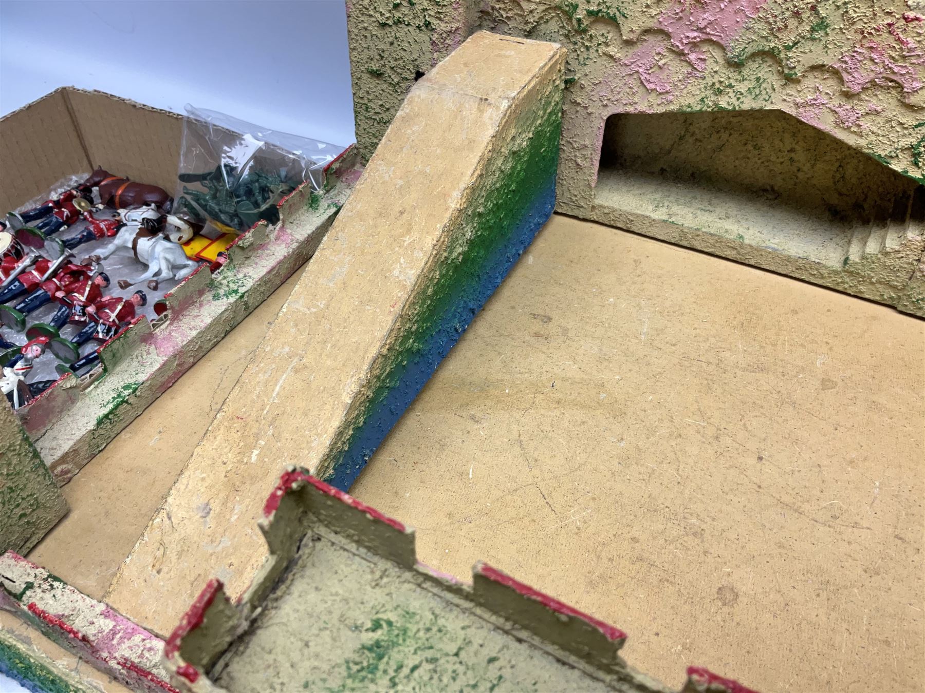 Sectional wooden fort on base with painted textured finish 46 x 36cm; together with over thirty lead and die-cast white metal soldiers and horses by various makers; and a small quantity of plastic figures of soldiers