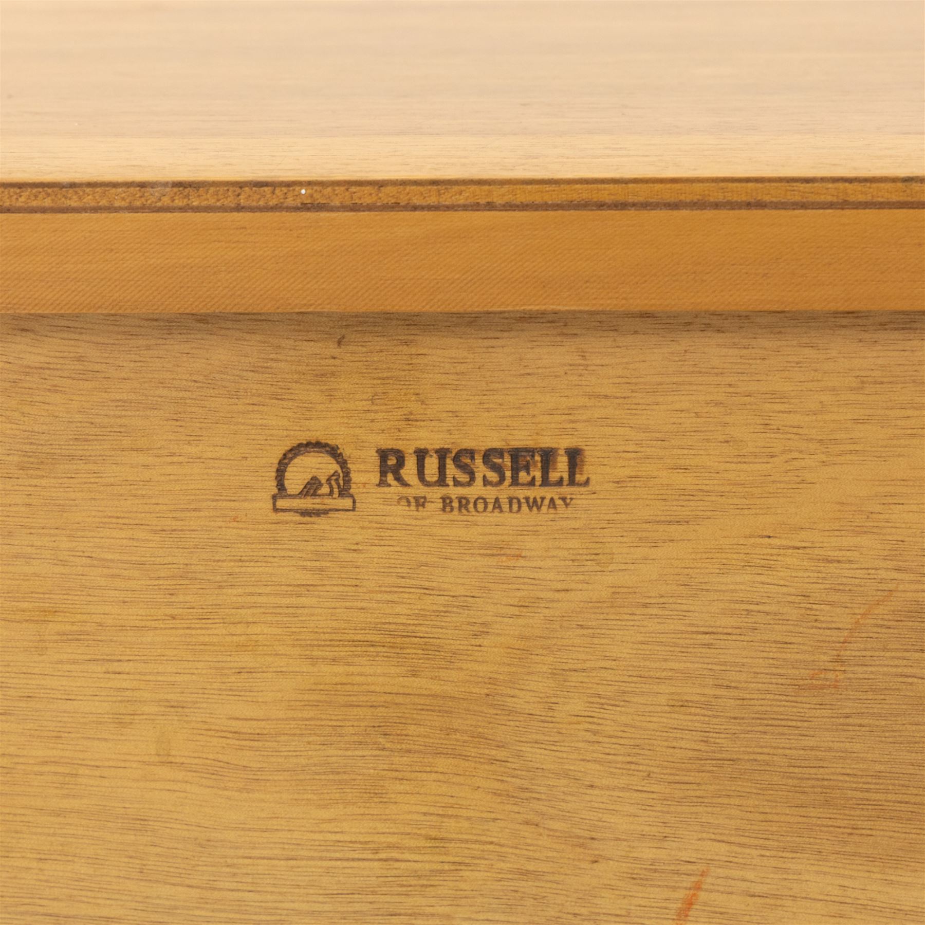 Gordon Russell - mid century modern teak sideboard, the rectangular top with rounded edges over twin cupboards and three central drawers, fitted with circular wooden pulls, on tapered supports, reflecting the firm’s commitment to simplicity and quality materials during the post-war design period