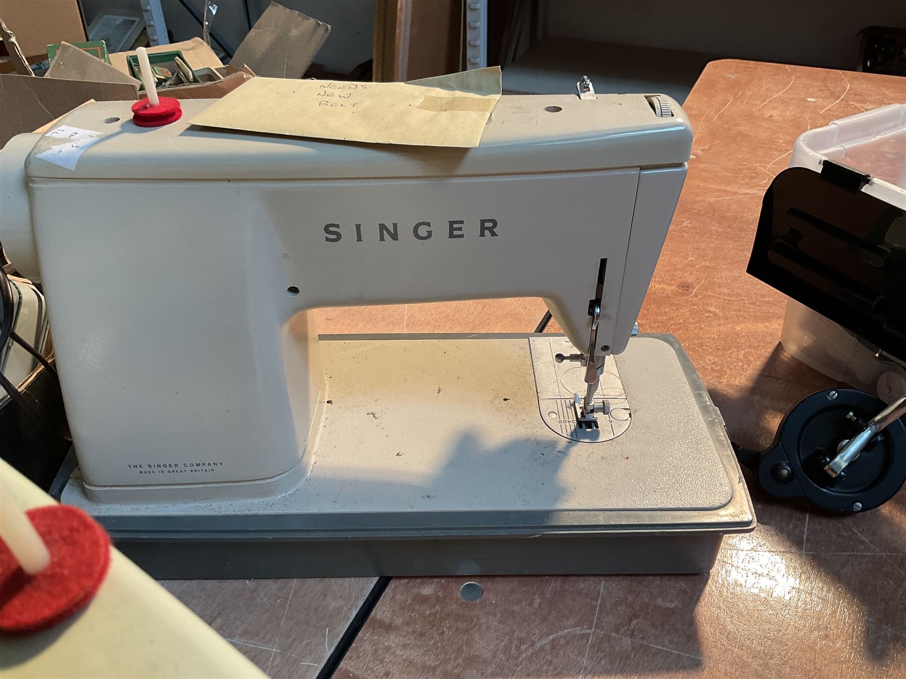 Two Singer sewing machines, model numbers 527 and 457, together with various Singer sewing machine parts, and a selection of sewing related accessories, to include threads, sewing needles, etc.