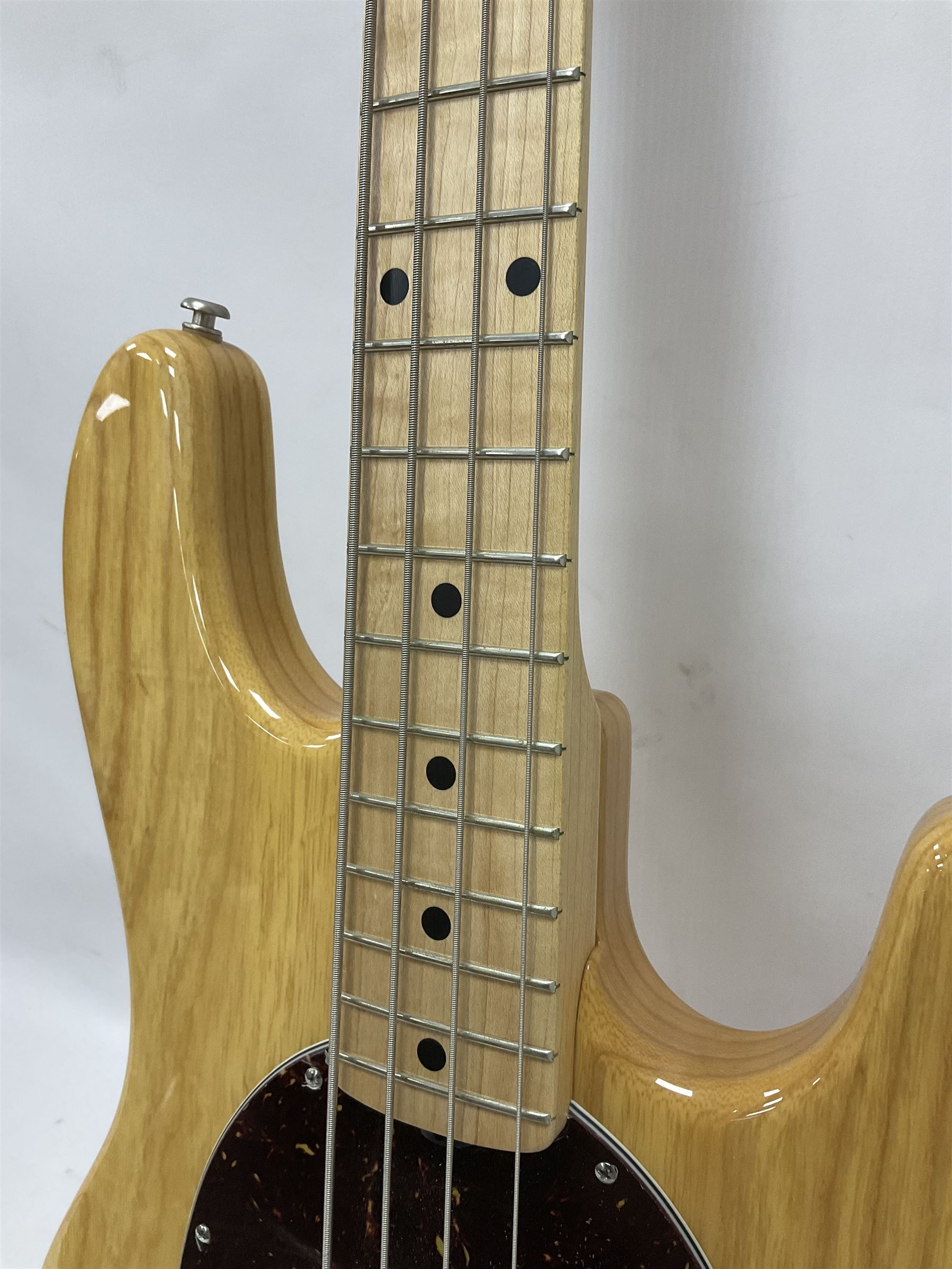 Ernie Ball Music Man Sting Ray 4 string bass guitar, in natural finish with roasted maple neck and tortoiseshell effect scratch guard, serial no 87485, in black Music Man hard case, guitar L114cm