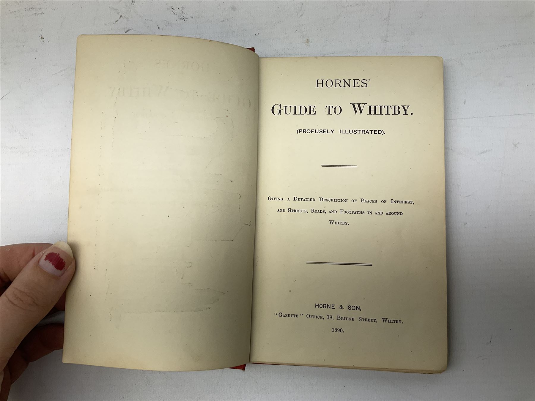Quantity of books and postcards predominantly of Whitby interest including Hornes' Guide to Whitby 1890 and Hornes' Tourist map of Whitby, A Holiday Tour in and Around Whitby by H.S. Forman 1896 etc