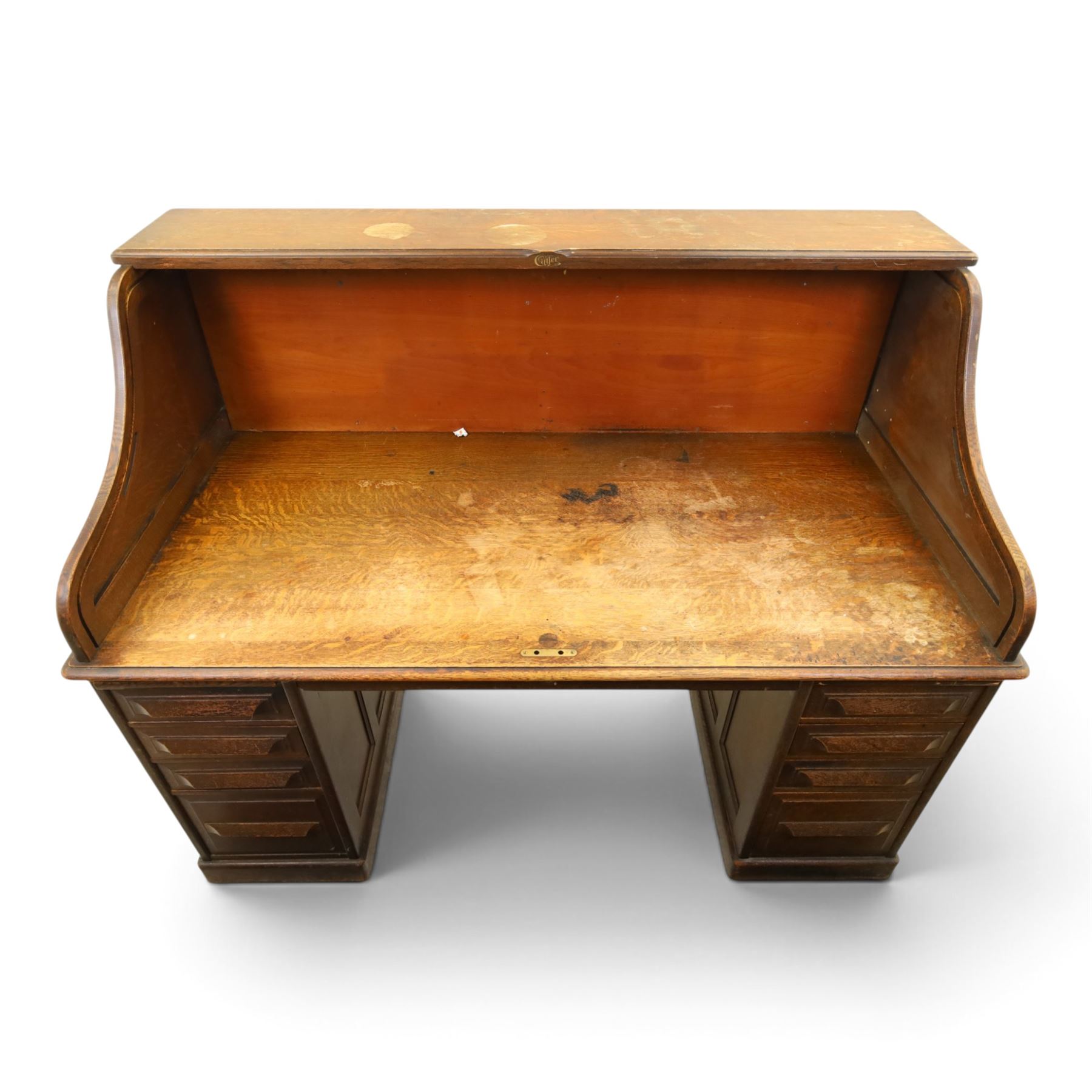 Cutler - Late Victorian oak pedestal tambour desk, the tambour shutter enclosing fitted interior, pull-out writing surface over central kneehole flanked by two pedestals each fitted with four drawers with moulded fronts, pull-out slides above, panelled sides, on moulded plinth base