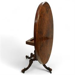 Victorian 19th century burr walnut oval centre table, hinged top above a carved pedestal supported on a scrolled carved quadruped base