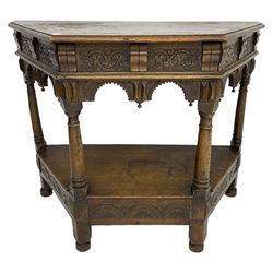Jacobean design carved oak side or credence table, demi-heptagon top with moulded edge, frieze carved with foliate C-scroll design above ornate arcade carved apron, under-tier united by ring turned pilisters, lower frieze carved with repeating lunettes