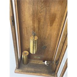 Early 20th century oak cased wall clock, the door glazed with circular convex dial glass and bevelled upright panes, circular brass and silvered Roman dial, twin train driven movement striking on coil 