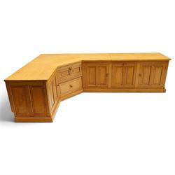 Seahorseman by Shaw & Riley - bespoke large Yorkshire oak corner sideboard or media unit, of L-shape form, with three cupboard doors, a fall front drawer over a regular drawer, a lift up panel for a record player, multiple apertures for wires, raised on a plinth base, with signature Seahorse carving from the workshop of A. Shaw & Riley Ltd, Hessay
