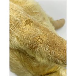1930s teddy bear, possibly Farnell, with wood wool filled blond mohair body, the revolving head with original clear glass eyes, shaved muzzle with vertically stitched nose and mouth and jointed limbs with five-stitch claws H18.5
