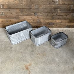 Set of three pressed metal planters in different sizes