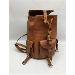 Mid-20th century plush covered teddy bear the revolving head with applied eyes, vertically stitched nose and jointed limbs with rexine pads H58cm; together with a leather backpack (2)