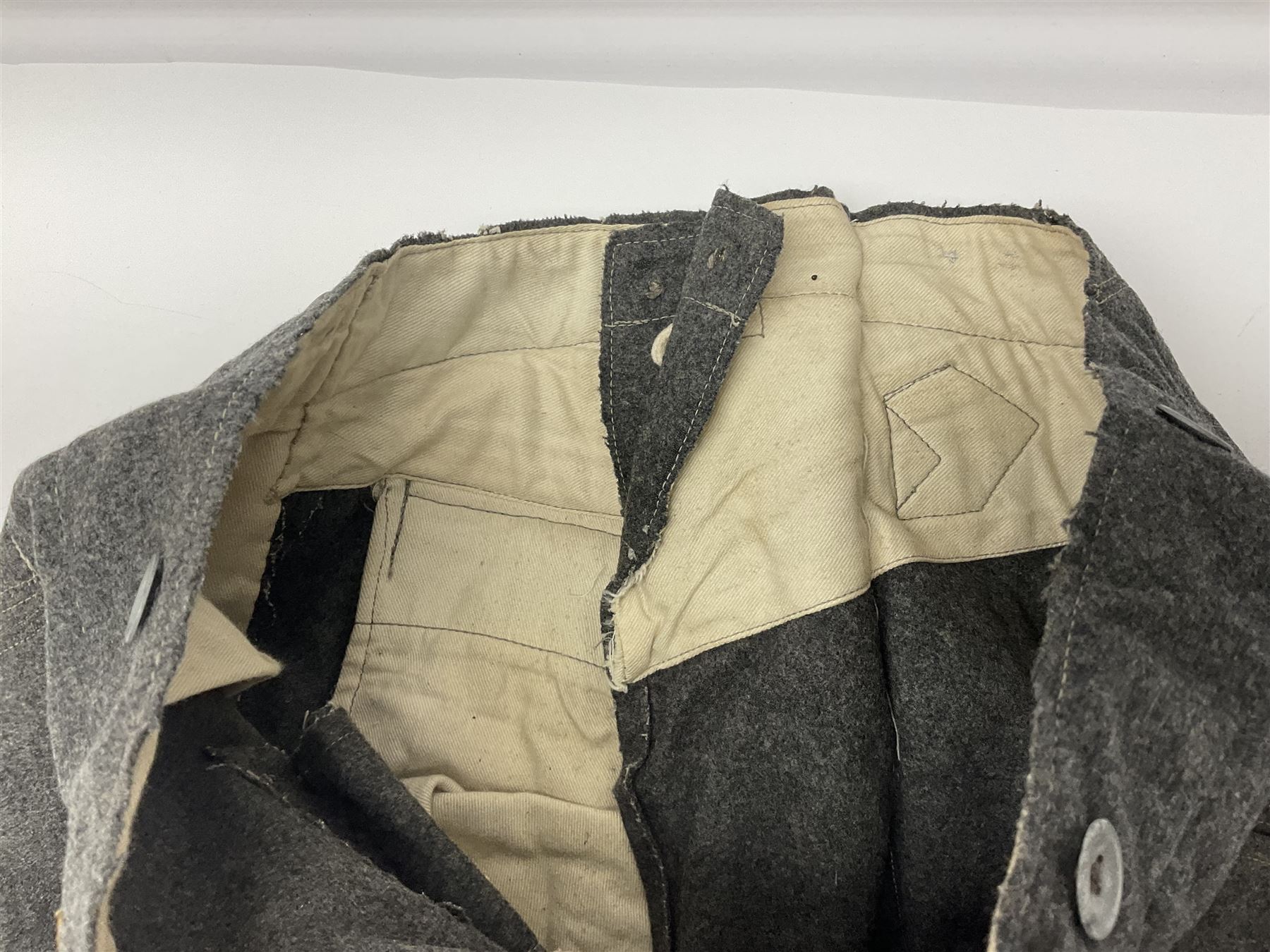 Pair of WW2 German Other Ranks trousers c1940-42, stamped C.& A. Brenninkmeyer Workstatten; WW2 German Army webbing belt with steel 'Gott Mit Uns' buckle; and WW2 German leather belt with 'Stahlhelm' (Steel Helmet League) members buckle (3)